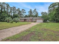 Charming brick home with a long driveway and mature trees, offering a serene and private setting at 475 Willard Rd., Conway, SC 29526