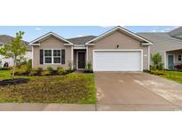 Charming one-story home featuring low-maintenance landscaping and an attached garage at 572 Woodland Farms Circle, Aynor, SC 29511