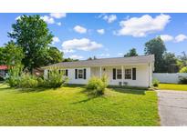 Charming home featuring well-maintained lawn, lovely front yard landscaping, and classic black shutters at 704 Bonnie Dr., Myrtle Beach, SC 29588