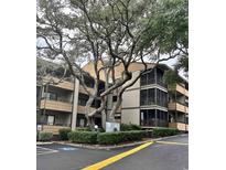 Condo exterior with a sign surrounded by foliage and mature oak trees adding shade to the complex at 9501 Shore Dr. # 323, Myrtle Beach, SC 29572