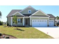 Charming home with a two-car garage, manicured lawn, and inviting front porch at 1004 Fowler Rd., Conway, SC 29526