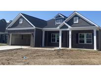 Charming new construction featuring a brick and gray color scheme with attached two-car garage at 1014 Black Locust Pl., Longs, SC 29568