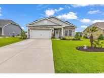 Charming single-story home featuring stone accents, manicured landscaping, and an attached two-car garage at 136 Crabapple Dr., Longs, SC 29568