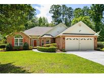 Charming brick home with a well-manicured lawn and a two-car garage at 1478 Bluegil Dr., Longs, SC 29568