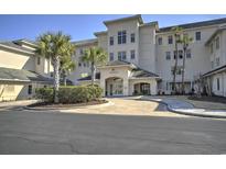 Elegant building exterior with lush landscaping and a welcoming entrance with interlocking brick drive at 2180 Waterview Dr. # 738, North Myrtle Beach, SC 29582