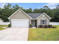 Charming single-story home featuring stone accents, a manicured lawn, and an attached two-car garage at 276 Avery Dr., Myrtle Beach, SC 29588
