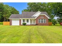 Charming single story brick home with attached garage and manicured front lawn at 2965 Mount Olive Rd., Loris, SC 29569