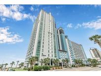 Stunning low-angle exterior view of the beachfront high-rise property on a sunny day at 3000 N Ocean Blvd. # 209, Myrtle Beach, SC 29577