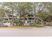 Well-maintained condos feature mature trees, lush landscaping and multiple levels with private balconies at 404 72Nd Ave. N # 301, Myrtle Beach, SC 29572