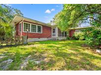 This home boasts a large backyard with screened porch and mature trees, perfect for outdoor living and relaxation at 506 28Th Ave. N, Myrtle Beach, SC 29577
