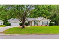 Charming single-story home with well-manicured lawn, mature tree and attractive landscaping at 556 Crusade Circle, Conway, SC 29526