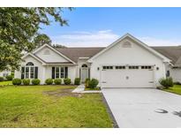Charming single story home with a two car garage and a well manicured front lawn at 583 Wildflower Trail, Myrtle Beach, SC 29579