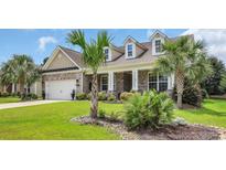 Charming brick home featuring a well-manicured lawn and palm trees at 698 Lafayette Park Dr., Little River, SC 29566