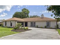 Charming single-story home with a well-manicured lawn and a neutral brick facade with black trim at 1008 Plantation Dr., Surfside Beach, SC 29575