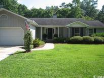 Charming single-story home with a well-manicured lawn and traditional architectural details at 1150 Waterway Dr., Myrtle Beach, SC 29572