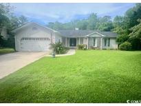 Charming home with a well-manicured lawn and an attached two-car garage at 1150 Waterway Dr., Myrtle Beach, SC 29572