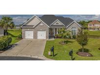 Charming brick home with a well-manicured lawn and two-car garage at 1323 Ashboro Ct., Myrtle Beach, SC 29579