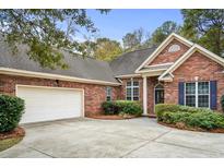 Beautiful brick home with a two-car garage, well-kept landscaping and a charming entrance at 192 Berkshire Loop, Pawleys Island, SC 29585