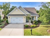 Charming single-story home featuring a two-car garage, well-maintained lawn, and tasteful landscaping at 2336 Tidewatch Way, North Myrtle Beach, SC 29582