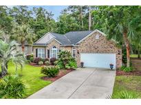 Charming brick home with a manicured lawn, lush landscaping, and a two-car garage at 327 Trestle Way, Conway, SC 29526