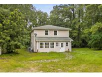 Two story home surrounded by lush trees and landscaping at 3534 Nichols Hwy., Galivants Ferry, SC 29544