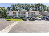 Inviting two-story condo building with balconies and well-maintained landscaping at 3681 Clay Pond Village Ln. # 3103, Myrtle Beach, SC 29579