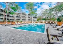 Inviting pool area with ample lounge chairs, providing a relaxing outdoor space for residents and guests at 415 Ocean Creek Dr. # 2373, Myrtle Beach, SC 29572
