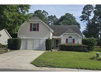 Charming two-story home with a well-manicured lawn, two car garage, and inviting curb appeal at 4570 Fringetree Dr., Murrells Inlet, SC 29576