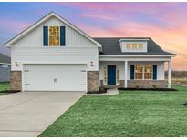 Charming two-story home with a manicured lawn and a white garage at 518 Woodside Dr., Conway, SC 29526