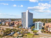 A high-rise condominium building with ocean views and a manicured landscape on a bright, sunny day at 5511 N Ocean Blvd. # 1603, Myrtle Beach, SC 29577