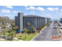 Beautiful ocean view condominium exterior with palm trees, beach access, and ample parking at 5905 South Kings Hwy. # A337, Myrtle Beach, SC 29575