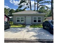 Charming single-story home featuring a gray exterior, well-manicured landscaping, and a wide concrete driveway at 613 Todd Blvd., Conway, SC 29526