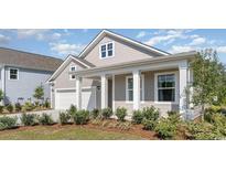 Charming two-story home featuring a covered entryway, attached garage, and professionally landscaped front yard at 719 Rupert Dr, Conway, SC 29526