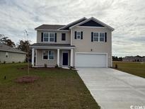 Inviting two-story home with a two-car garage and a well-manicured lawn at 3557 Ashridge Way, Conway, SC 29526