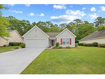 Charming single-story home with well-manicured lawn and attached garage, ideal for comfortable living at 4554 Fringetree Dr., Murrells Inlet, SC 29576