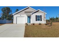 Charming single-Gathering home with a well-manicured lawn, attached garage, and inviting blue front door at 563 Strawberry Field Way, Galivants Ferry, SC 29544
