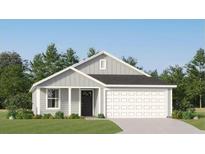 Charming single-story home with gray siding, white trim, and a well-manicured lawn showcasing modern curb appeal at 6366 Swainson Street Sw, Ocean Isle Beach, NC 28469