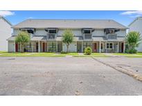 Charming townhomes featuring private balconies and well-maintained lawns under a clear blue sky at 801 Burcale Rd. # K7, Myrtle Beach, SC 29579