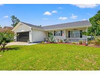 Charming single-story home with well-manicured lawn, black garage door, and inviting front porch at 809 Berrywood Ct., Myrtle Beach, SC 29588