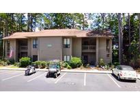 Condo with neutral toned siding and nicely manicured shrubs and bushes in a well landscaped community at 1102 Indian Wells Ct. # 2, Garden City Beach, SC 29576