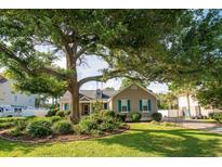 Charming home with mature trees, lush landscaping, and a well-manicured lawn at 174 Edward Ave., Murrells Inlet, SC 29576