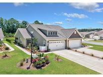 Beautiful single-Gathering home with a two-car garage, manicured lawn, and inviting curb appeal at 204 Kinross Ct., Little River, SC 29566