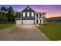 Charming home with a three-car garage, covered porch, and well-manicured lawn at 2212 Leeboard Ct., Myrtle Beach, SC 29579