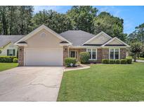 Charming single-story home with brick accents, manicured lawn, and two-car garage on a sunny day at 2510 Oriole Dr., Murrells Inlet, SC 29576