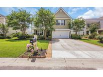 Charming two-story home featuring a well-manicured lawn, inviting curb appeal, and an attached two-car garage at 2685 Scarecrow Way, Myrtle Beach, SC 29579