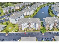 Expansive aerial view of condo community with lake, fountain, manicured lawns and abundant parking spaces at 4821 Luster Leaf Circle # 202, Myrtle Beach, SC 29577