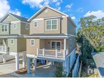 Two story home with a covered patio and ground-level parking beneath the elevated living space at 505 Chester St 5Th Ave. N, Myrtle Beach, SC 29577