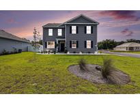 Charming two-story home with gray siding, black shutters and manicured front yard at 651 Choctaw Dr., Conway, SC 29526