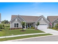 Charming single-story home with well-manicured lawn and a two-car garage, creating a welcoming curb appeal at 7374 Sarteano Dr., Myrtle Beach, SC 29572