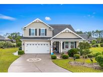 Charming two-story home with a well-manicured lawn, beautiful landscaping, and a welcoming front porch at 908 Ashbourn Ct., Murrells Inlet, SC 29576